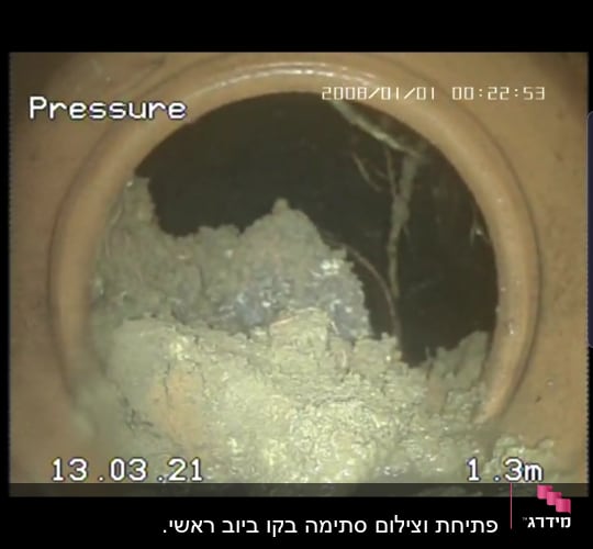 תמונה מתוך צינור עם חסימה של בוץ וענפים